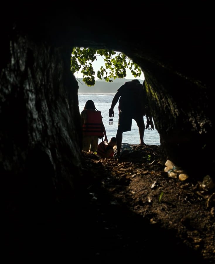 Royal Cruise guests walking out of the Mystery Cave towards the sea, Gokarna