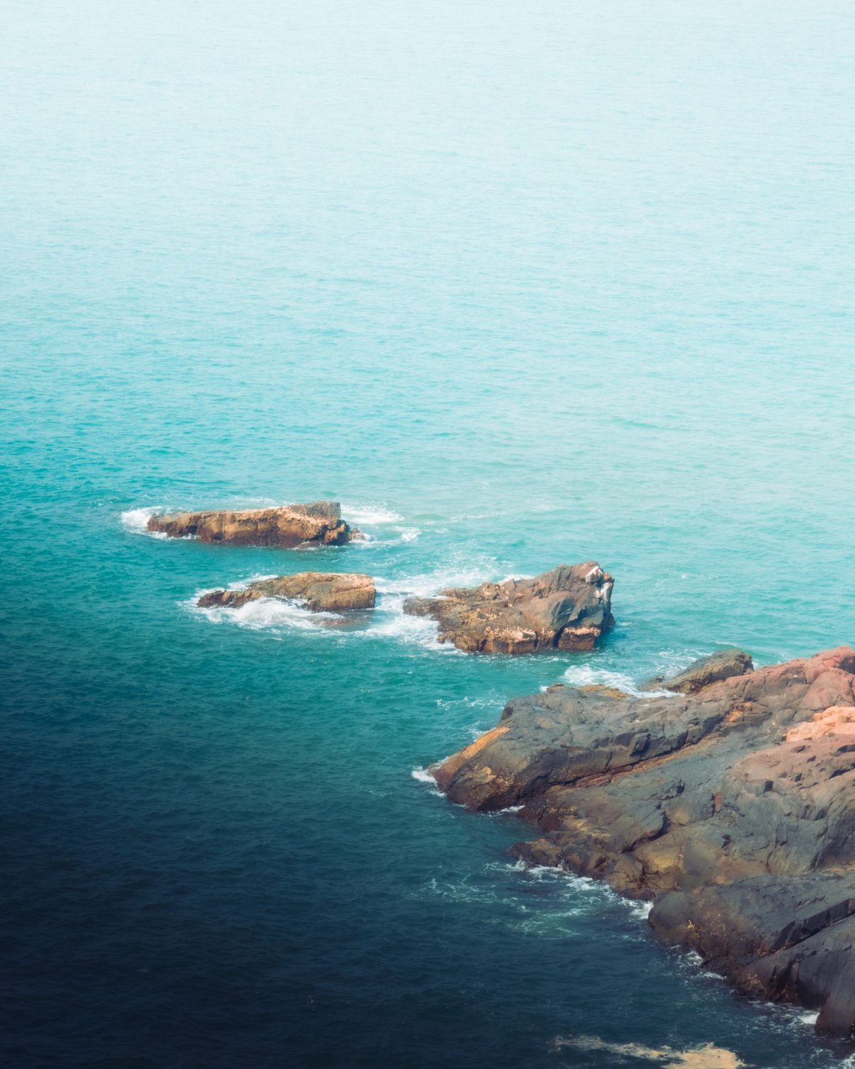 Turquoise sea around the rocks of Gokarna, from above